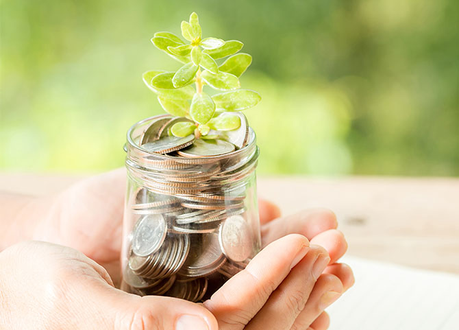 Woman holding a jar of coins